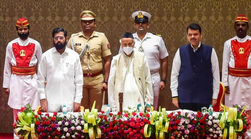 Maharashtra Governor (centre), CM Eknath Shinde (left) and Deputy CM Devendra Fadnavis (right) stand in attention as the nation anthem plays in the background at Raj Bhavan on 30 June 2024