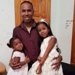 Samuel Badree with his daughers