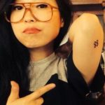 Awkwafina showing her tattoo