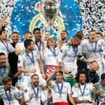 Luka Modric with his Real Madrid teammates holding Champions League Trophy in 2018
