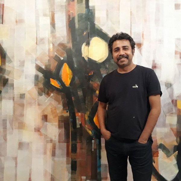 Pankaj Jha with his painting in backdrop