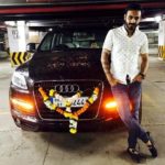 Naitik Nagda poses with his Audi Q7 car