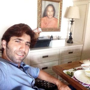 Sumit Kaul poses with his guru Paramahansa Yogananda's photo frame