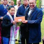 Mirabai Chanu receiving check from N. Biren Singh