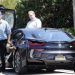 Pierce Brosnan coming out of his car BMW i8