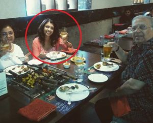 Tina Desai drinking with her parents