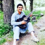 Hazratullah Zazai Playing The Guitar