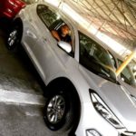 Nicholas Pooran poses with his car