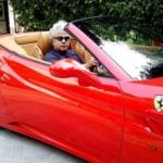 Suhel Seth poses with his Ferrari California car