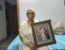 Wife of Ravi Khanna with his photograph