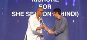 Kishore Kumar G posing with his Best Actor in a Negative Role Award at OTT Play Awards